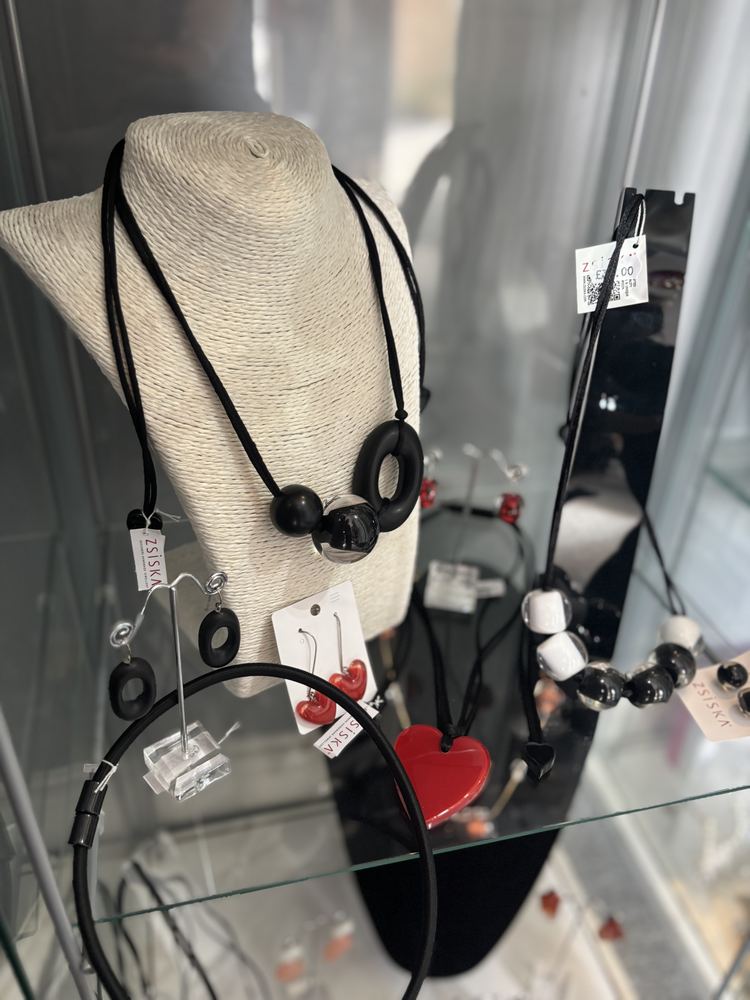 Necklaces and earrings displayed on a jewellery bust in the shop